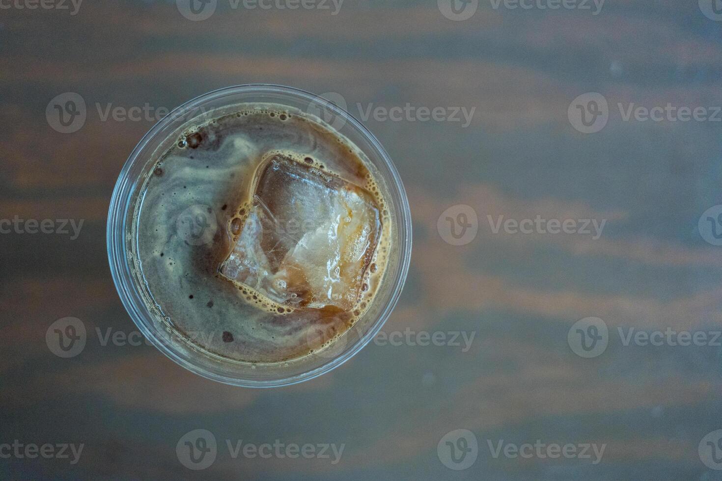 Iced Americano or black coffee with a big of square ice cubes photo