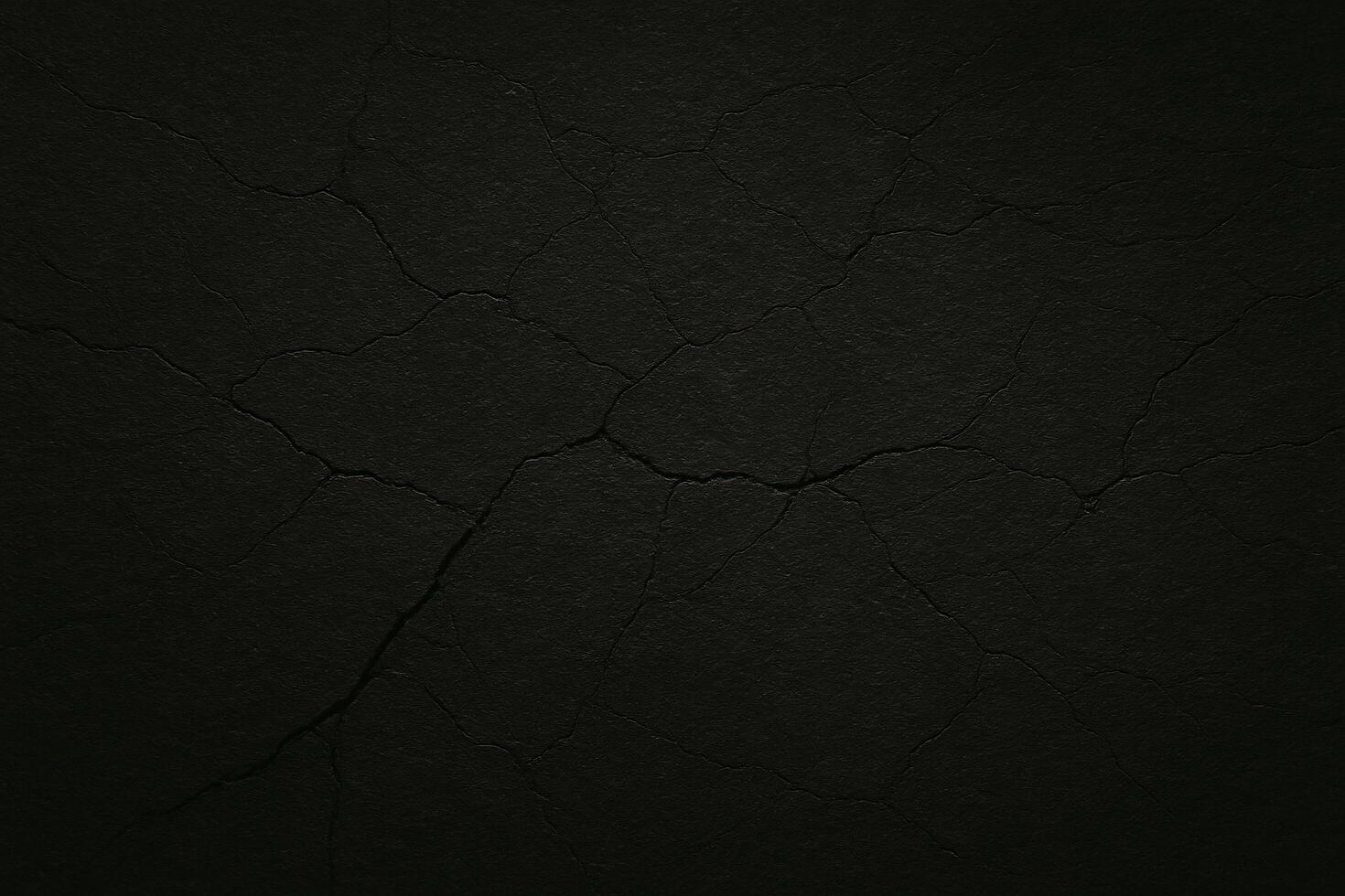 Dark cracked concrete texture with dramatic lighting and deep fissures, perfect for backgrounds, grunge designs, or abstract visual projects photo