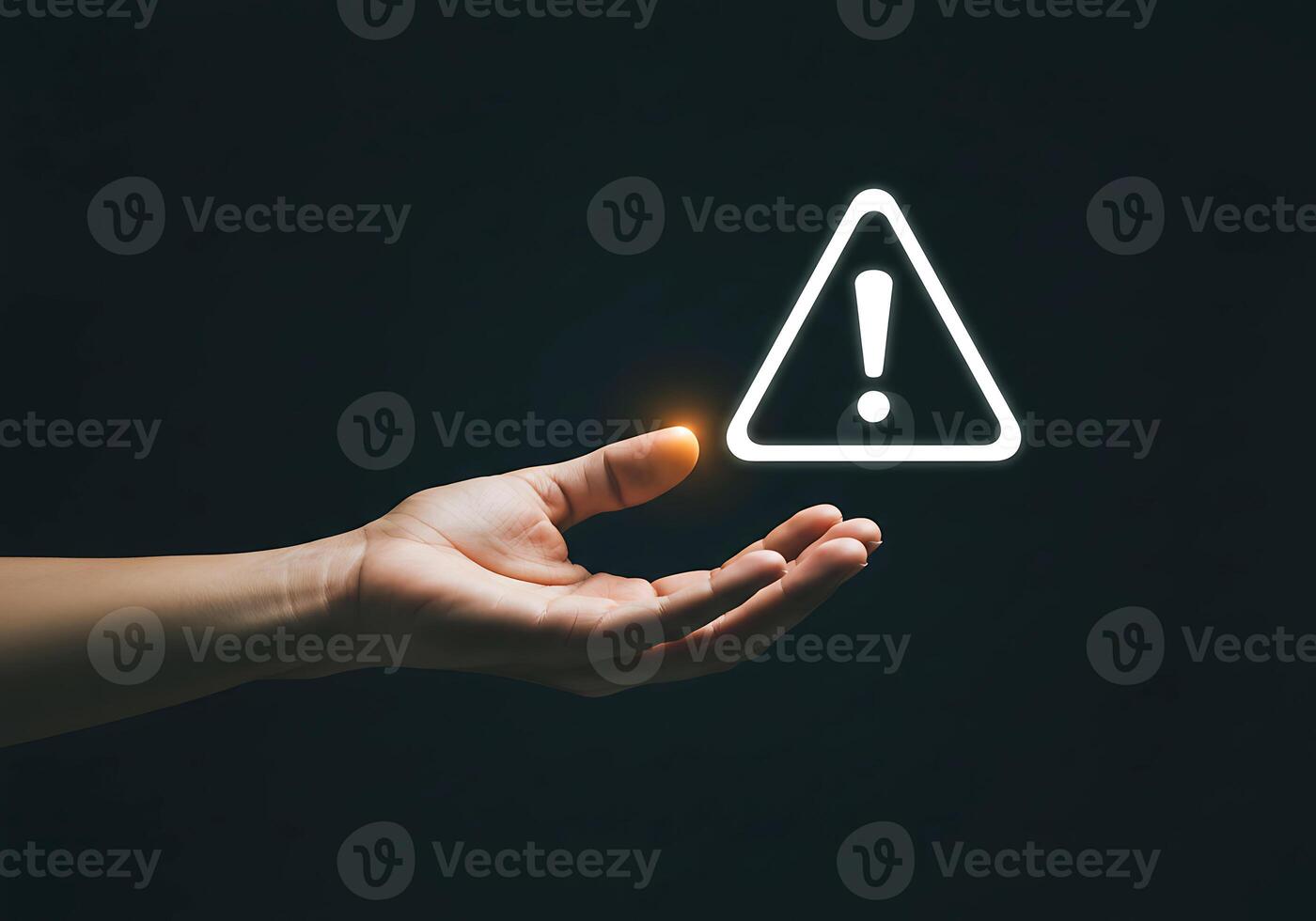 A hand holding a warning sign with a glowing light photo