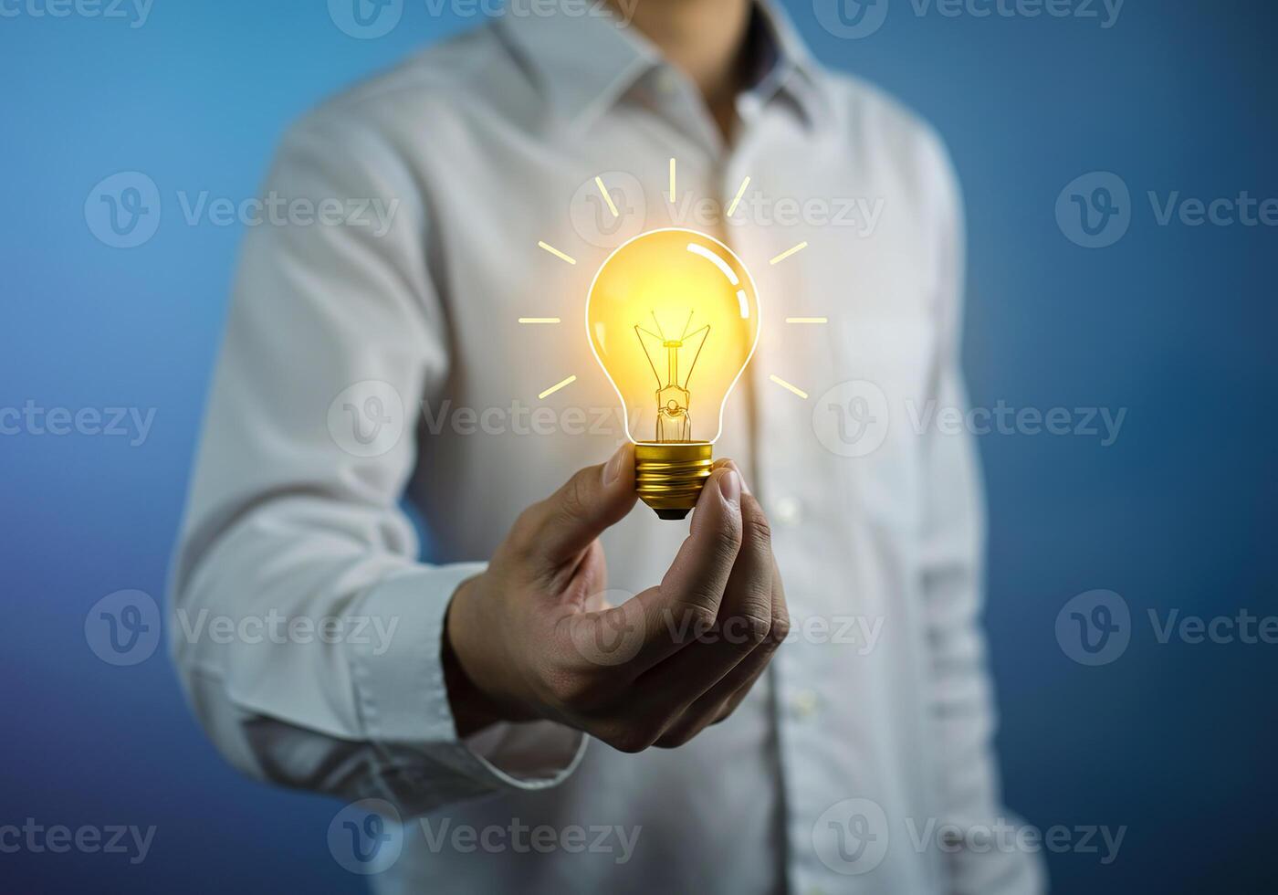 A man holding a light bulb in his hand photo