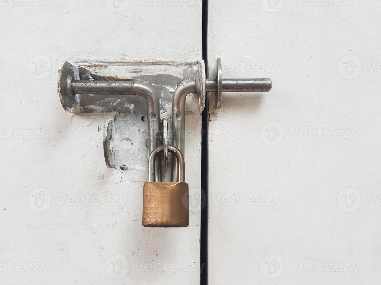 Lock on a white metal gate photo