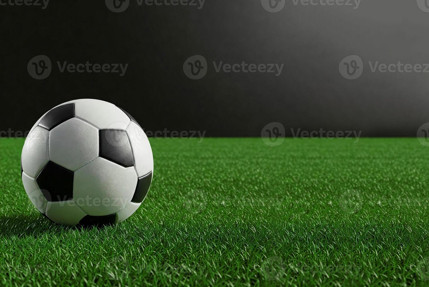 Classic black and white soccer ball on vibrant green grass with dark gradient background. Ideal for sports, training, competition, or recreational themes. Banner, copy space. photo