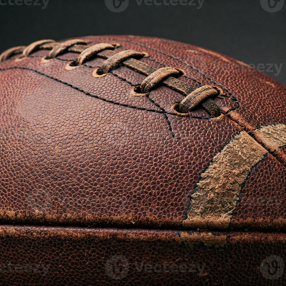 Detailed close up of worn leather American football. The leather texture, scuffs, and textured lacing are clearly visible. Ideal for sports themes, nostalgia, craftsmanship, and athletics. photo