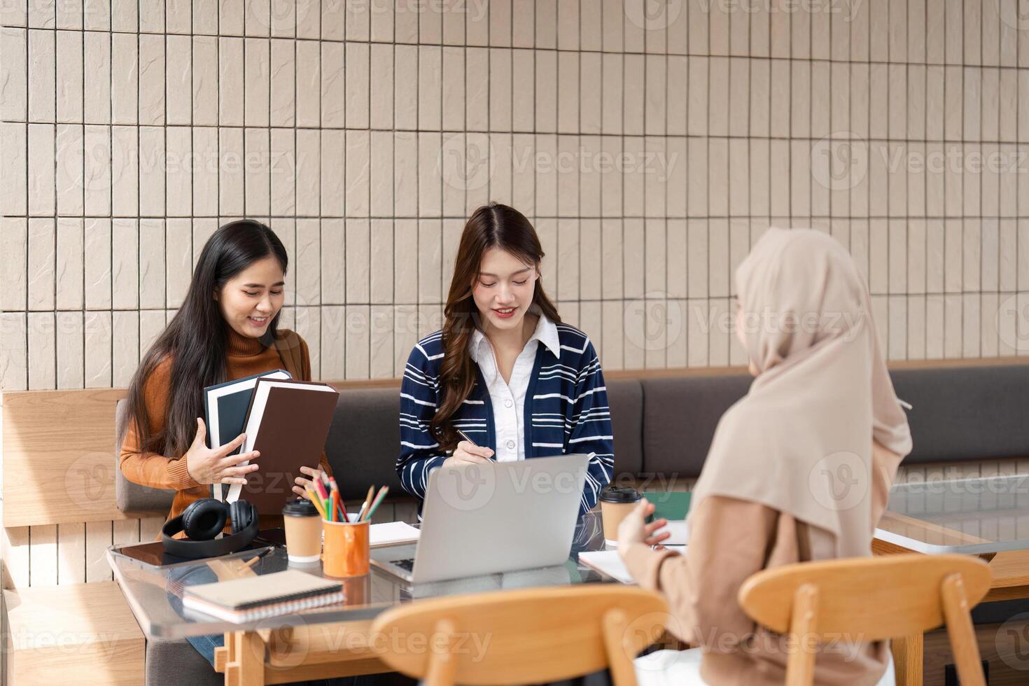 Group Learning and Inspiration. Three friends gather to study and share ideas in a collaborative setting. photo