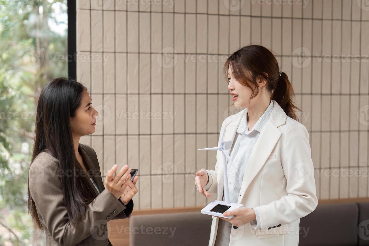 Professional Dialogue and Strategy. Women discussing sustainable energy solutions in a collaborative environment. photo