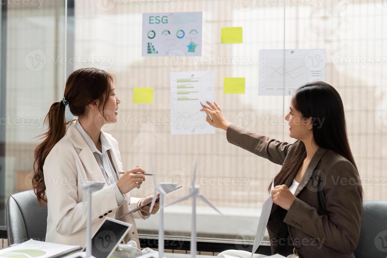 Environmental Strategy Planning. Professionals discussing ESG insights and sustainable initiatives in a collaborative environment. photo