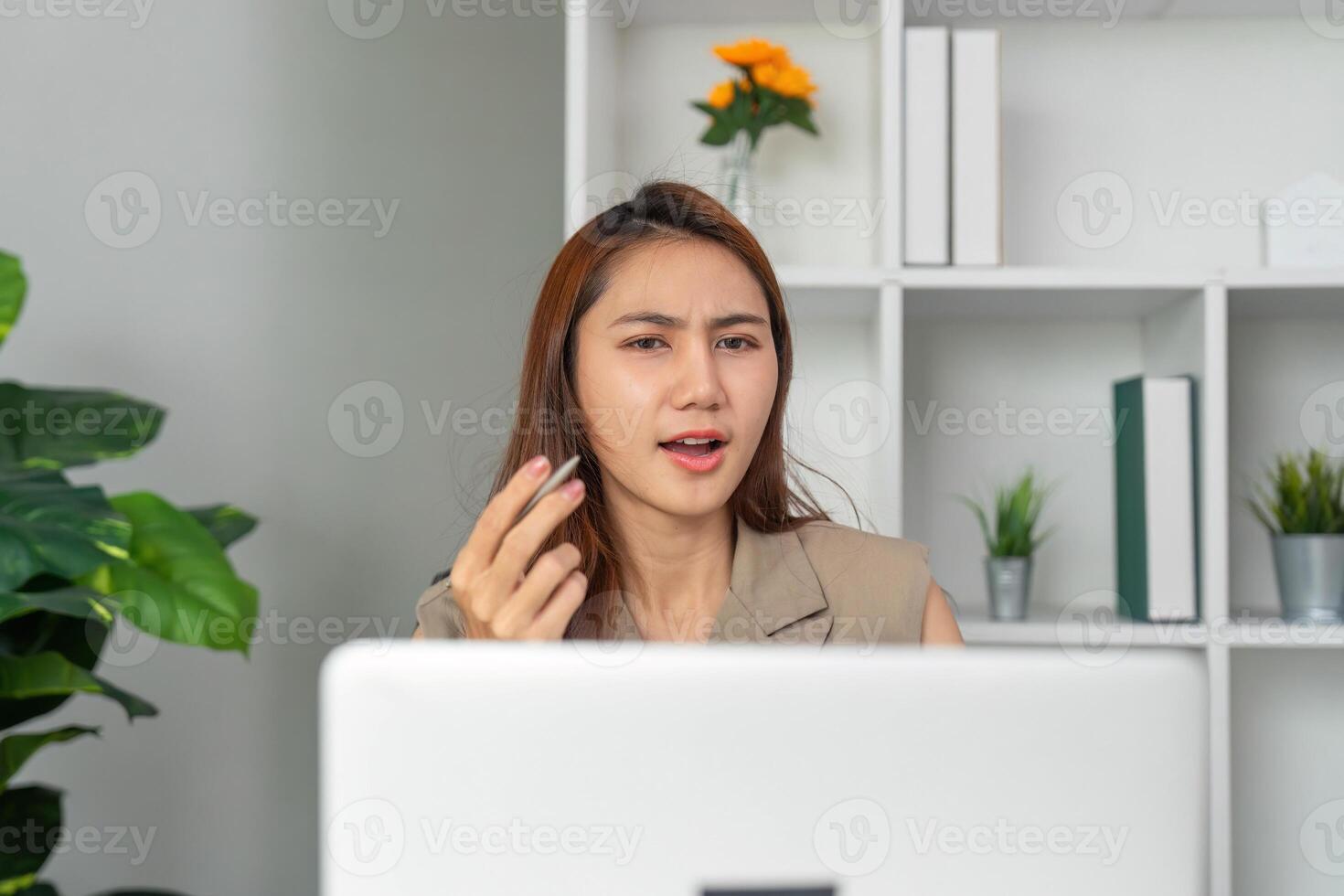 Effective Communication and Problem Solving. A woman expresses concern and seeks clarity during a virtual discussion. photo