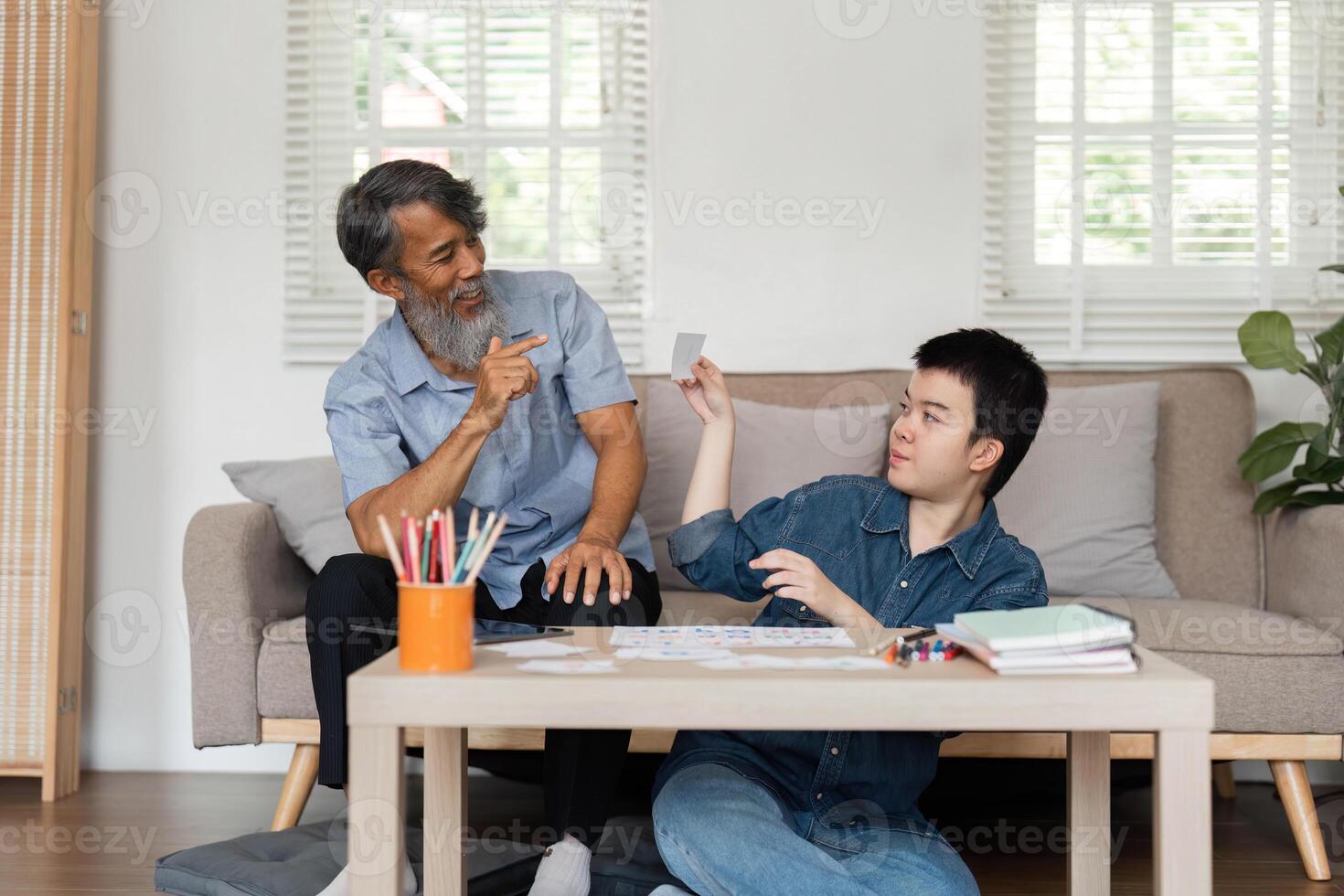 Educational Interaction and Support. A grandfather and his grandson with Down syndrome engage in learning activities. photo