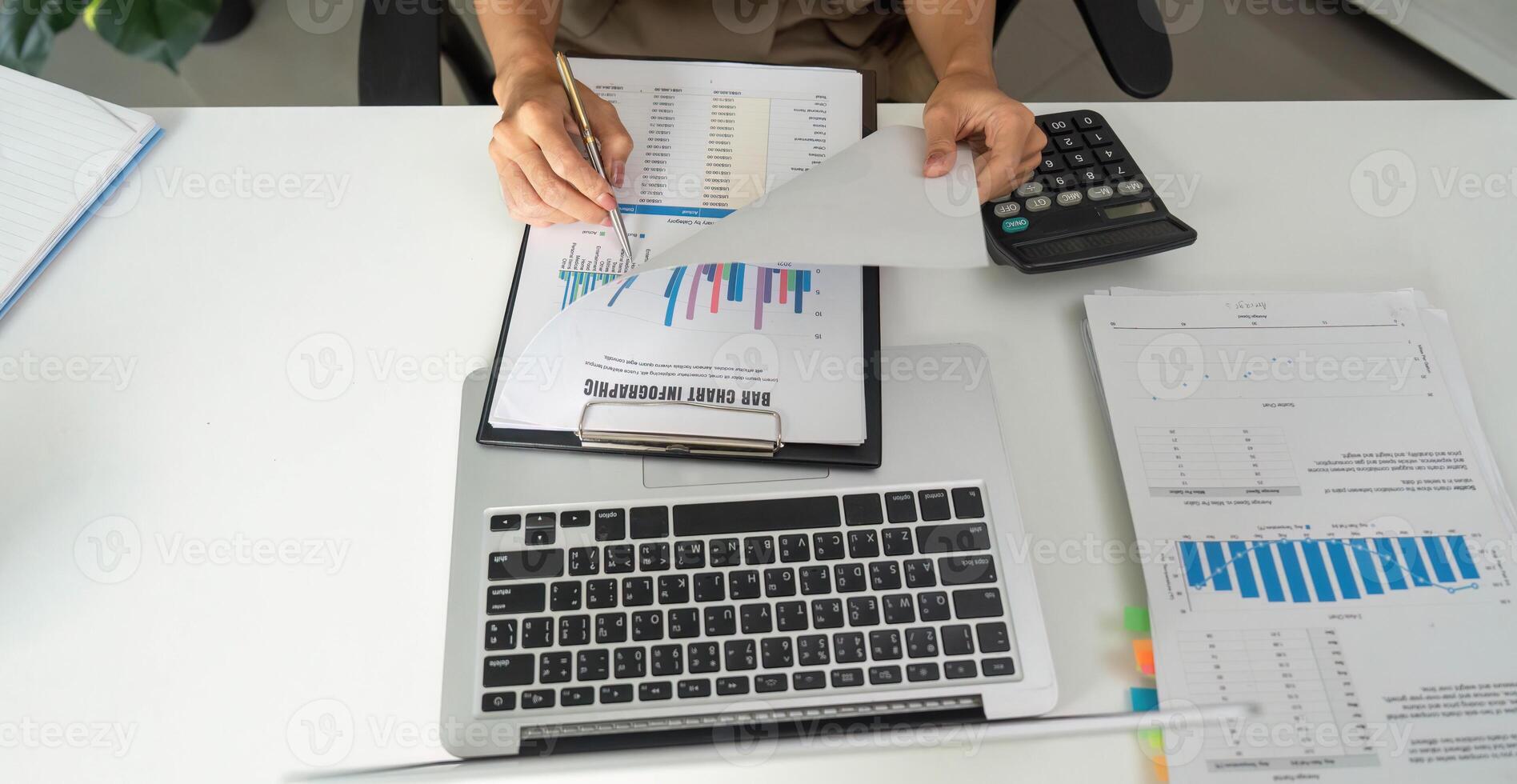 Financial Organization and Data Review. An individual sorting through financial reports and documentation on a desktop. photo