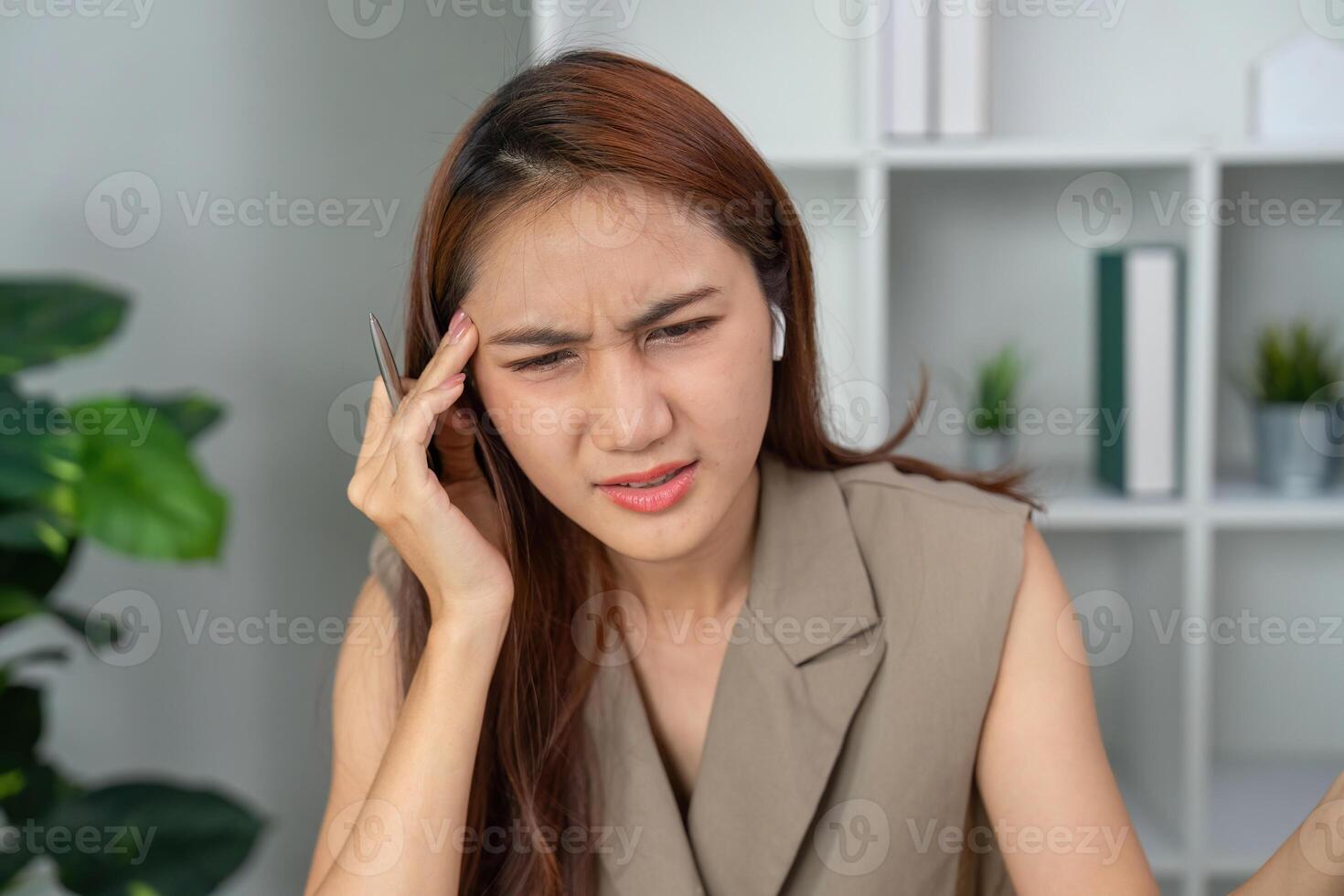 Mental Health and Concentration. A woman showing signs of frustration during her work evaluation, reflecting on her mental well-being. photo