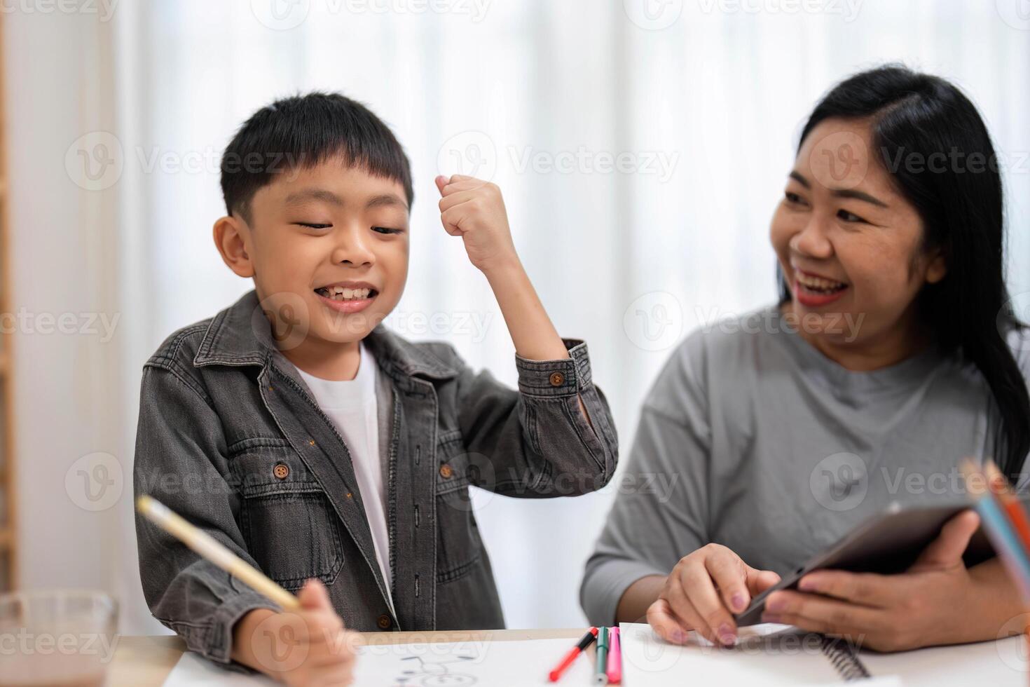 Back to School and Celebrating Achievements. A boy expresses excitement after completing a task. photo