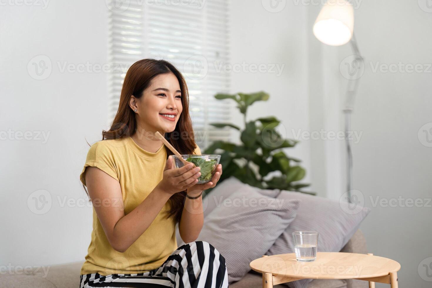 Morning Routine and Healthy Eating. A woman enjoying a nutritious salad as part of her morning routine. photo