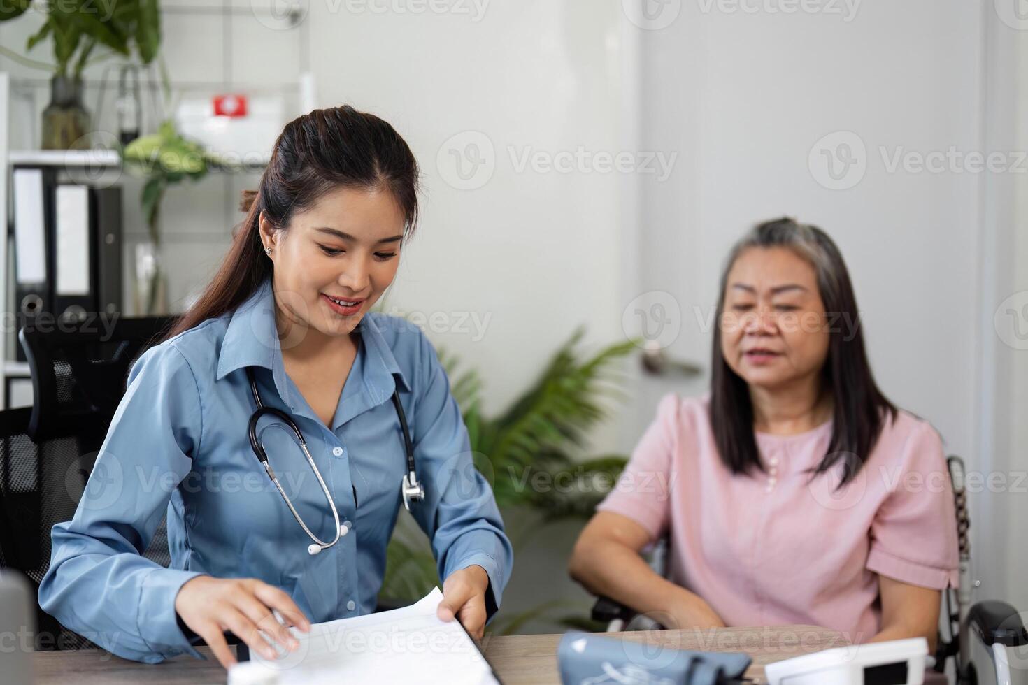 Health Check and Interaction. A nurse documenting care while interacting with a senior patient. photo