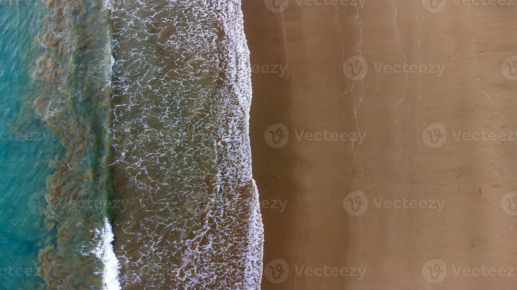 Aerial View of Waves Crashing on Sandy Beach, East Java, Lenggoksono Beach photo