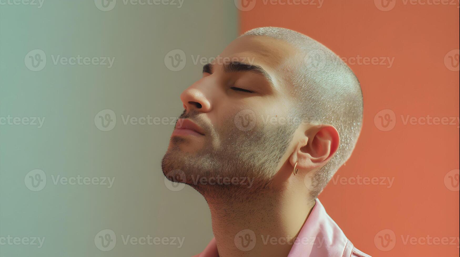 Serene profile of a young bald man meditating in a vibrant pastel colored background photo