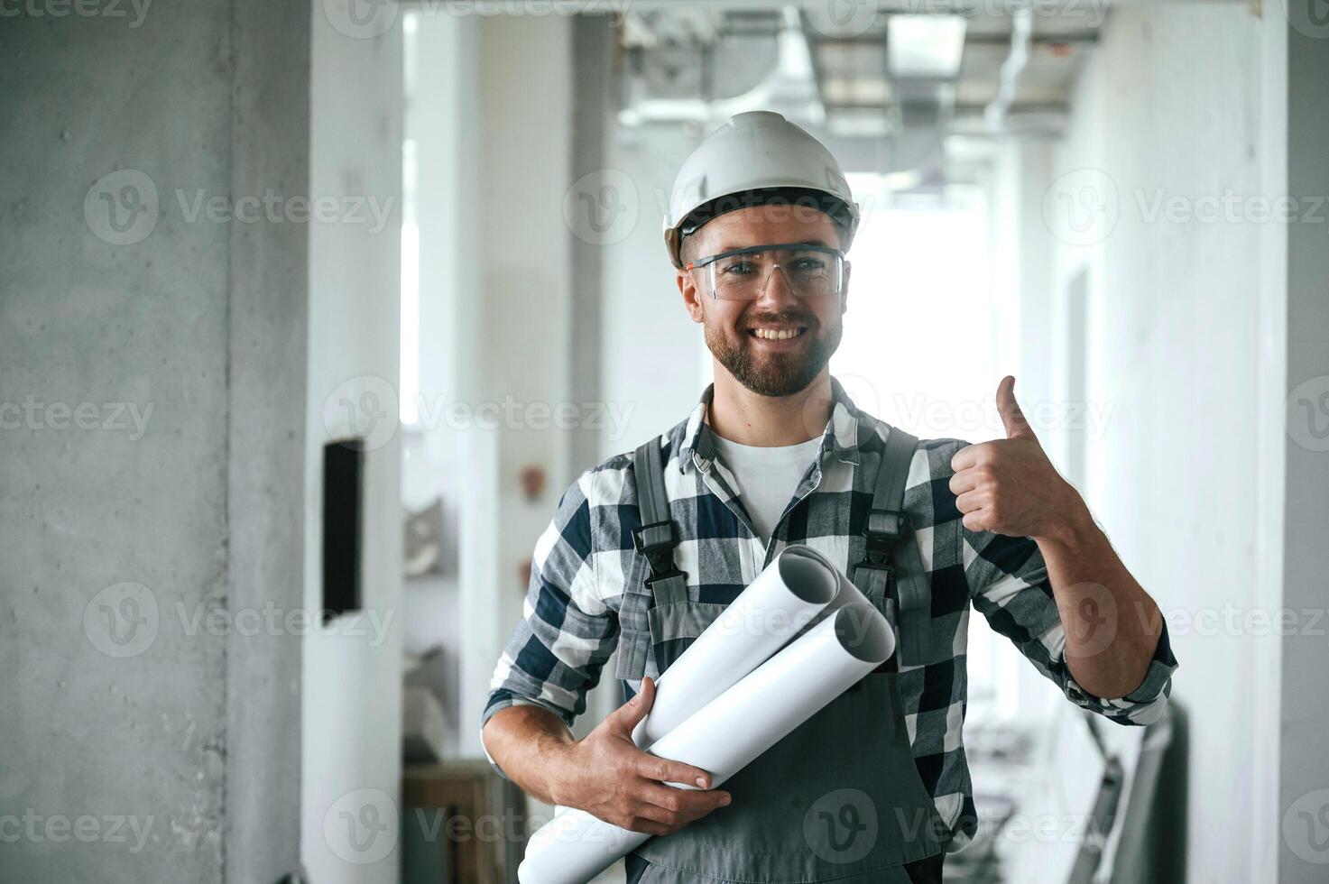 Construction worker in uniform in empty, unfinished room photo