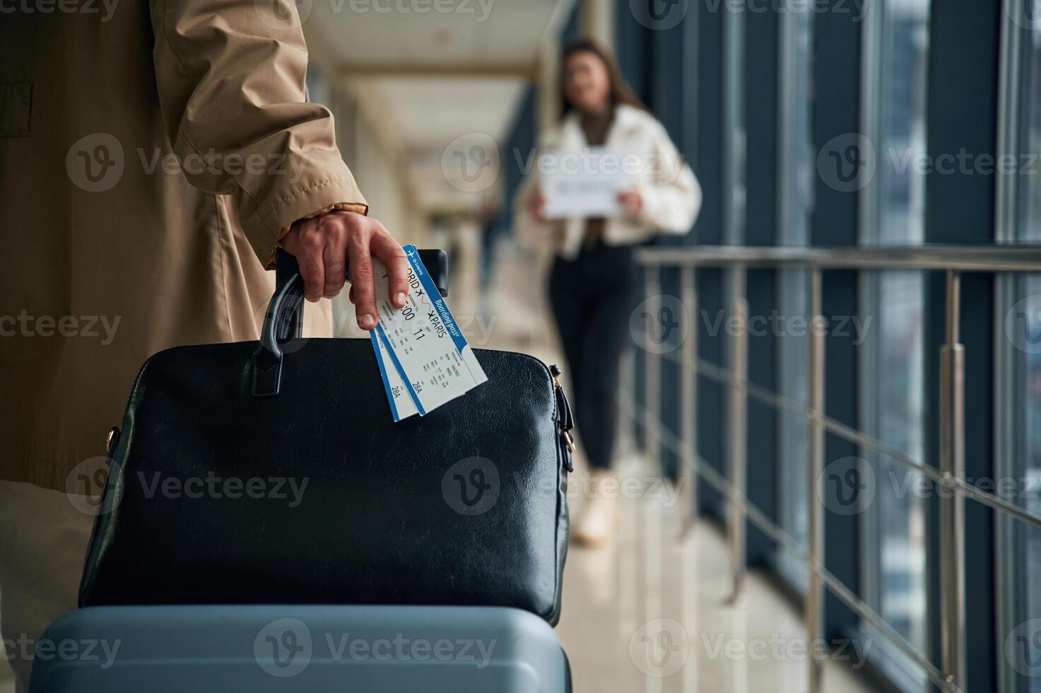 Man,, arrives from the flight in the airport entrance hall, woman is meeting him with name blank photo