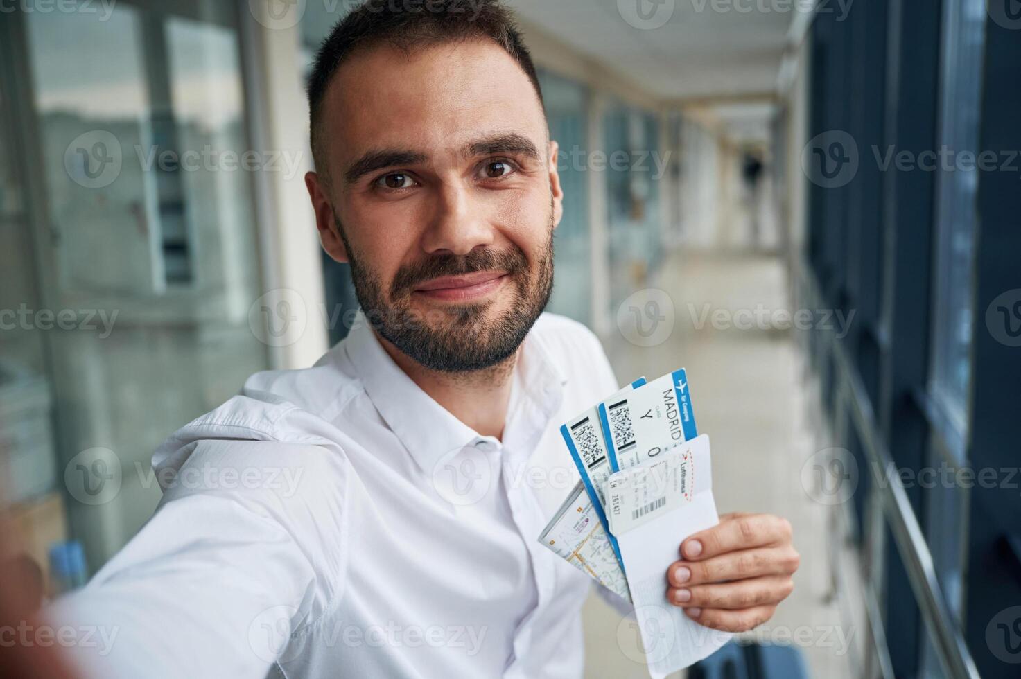Making, selfie, happy facial expression. Young handsome man in the airport photo