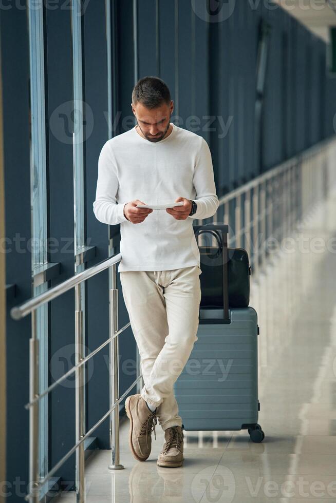 In ,,formal clothes. Young handsome man in the airport photo