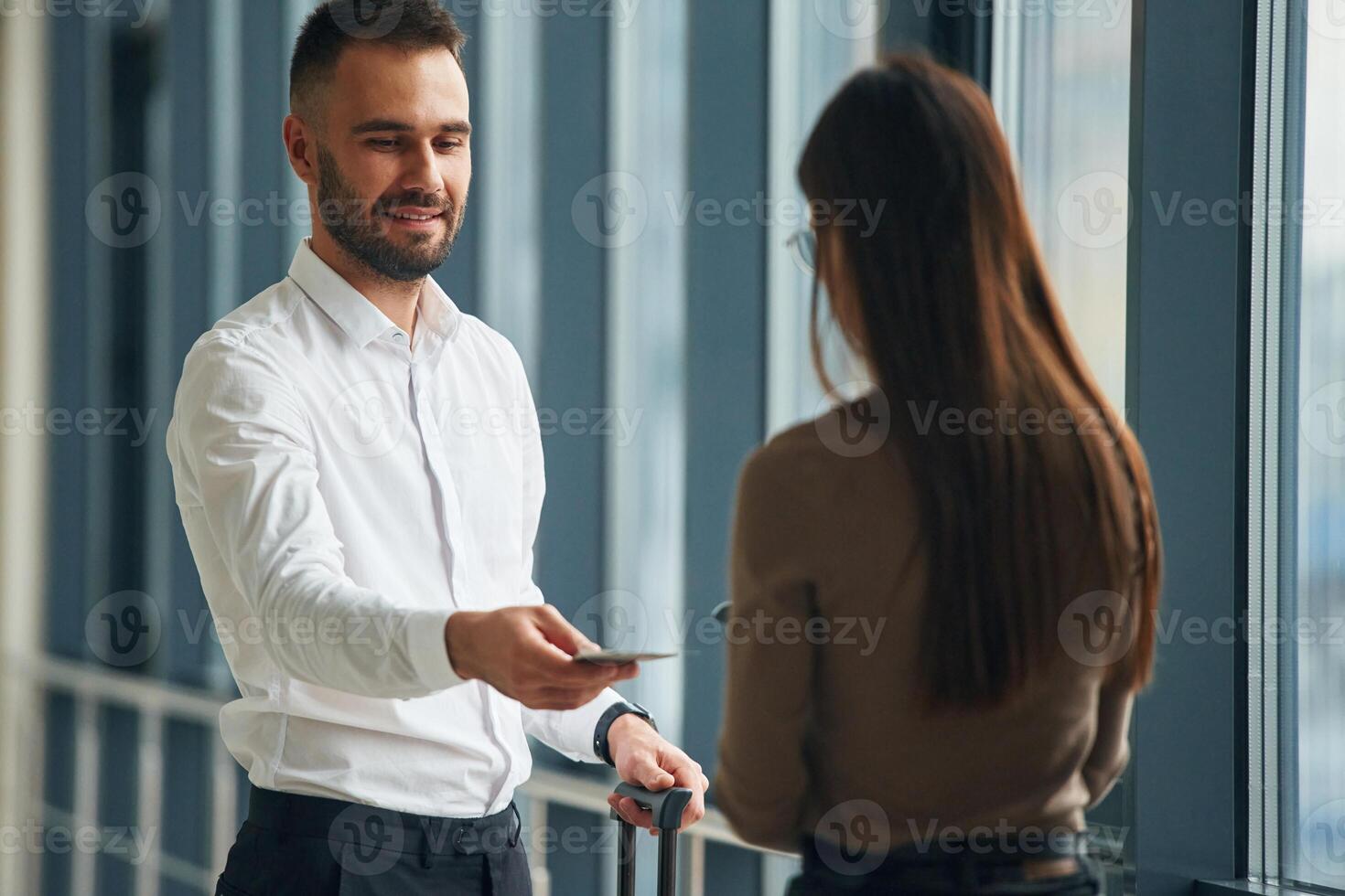 Woman, is with airport, worker, with tickets photo