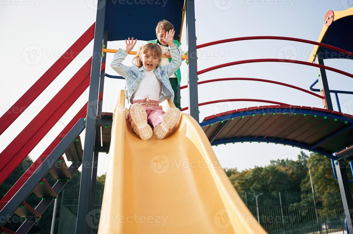 Beautiful sunlight. Kids are,, having fun on the playground photo