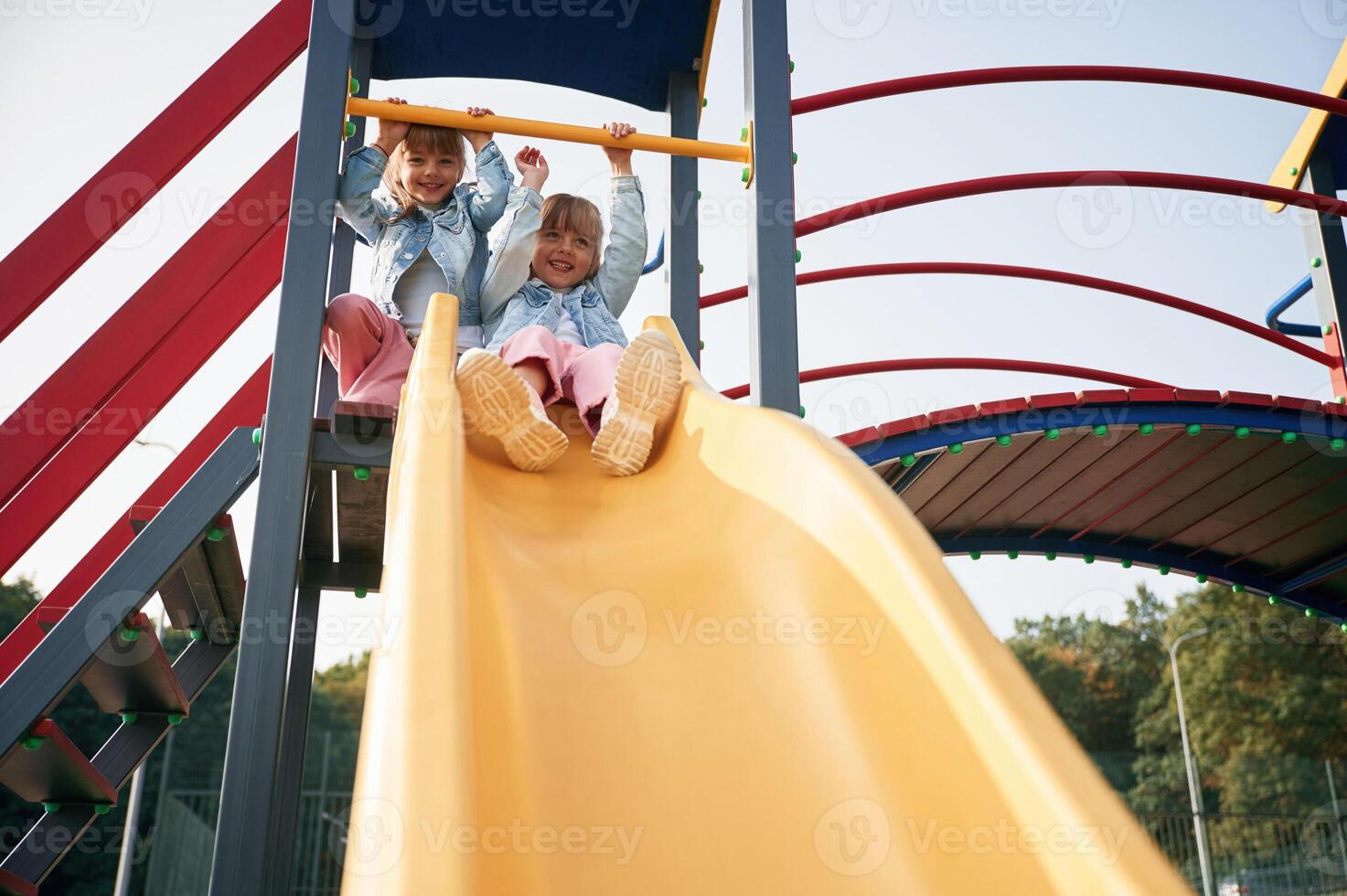 On the playground slide. Kids are having fun photo