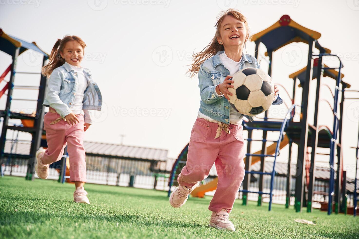 Front view. Kids are having ,fun on, the playground photo
