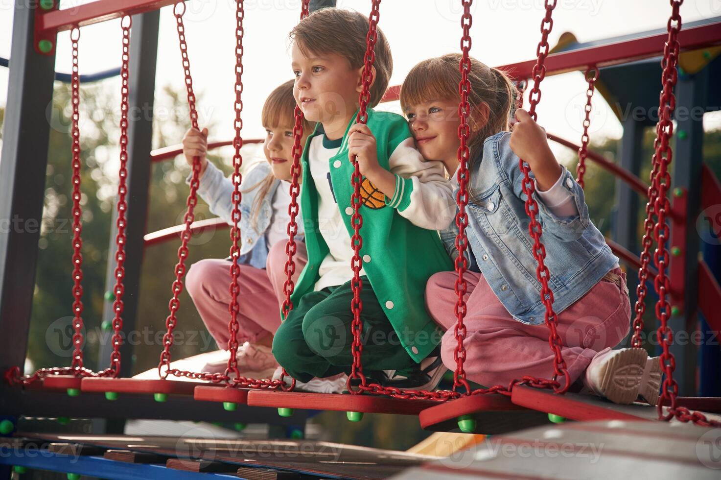 Two girl and one boy. Kids are having, fun on the playground photo