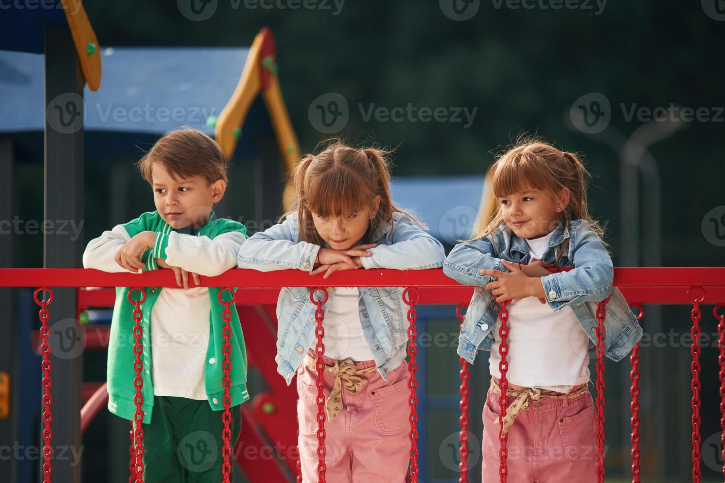 Children,, are active, smiling. Kids are having fun on the playground photo