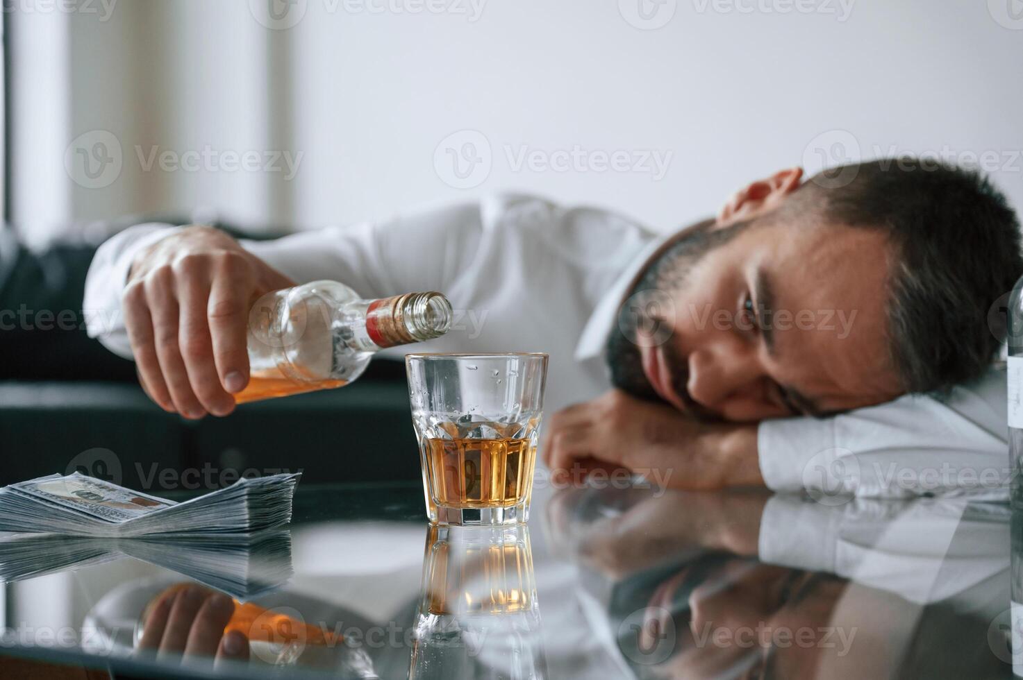 Conception of, addiction. Upset ,young man drinker alcoholic is indoors photo