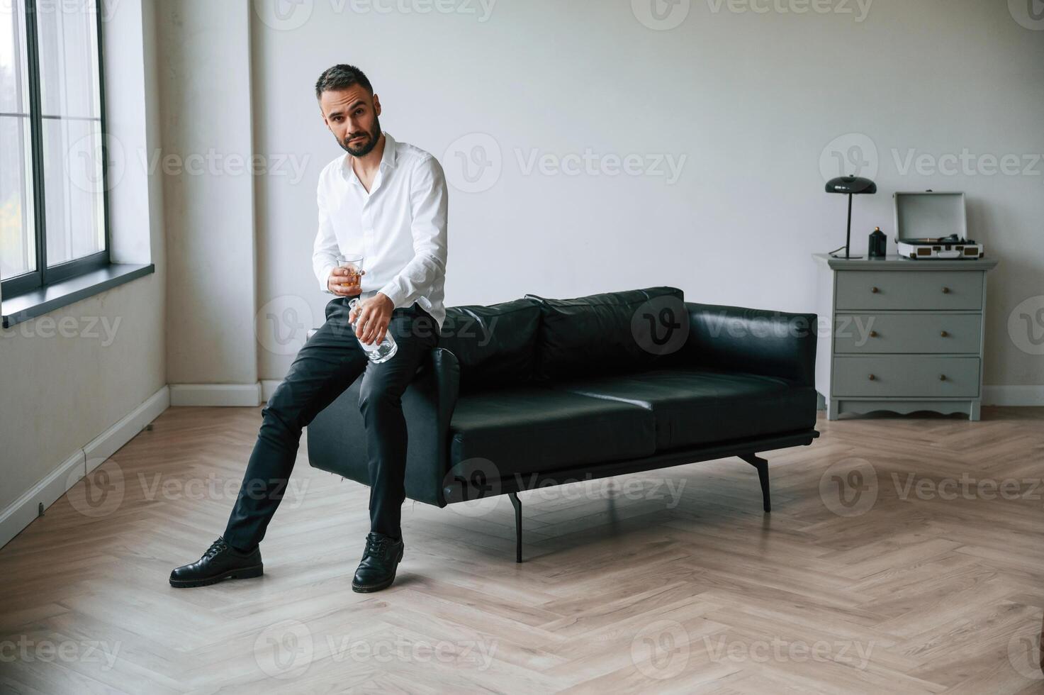 In, formal, clothes. Business failure. Upset young man drinker alcoholic is indoors photo