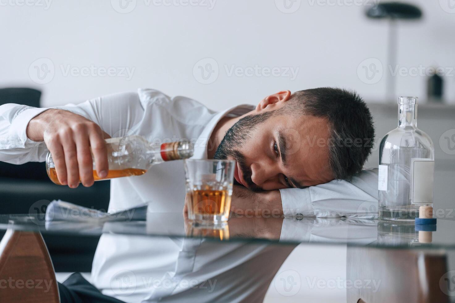 Life crisis... With whiskey. Upset young man drinker alcoholic is indoors photo