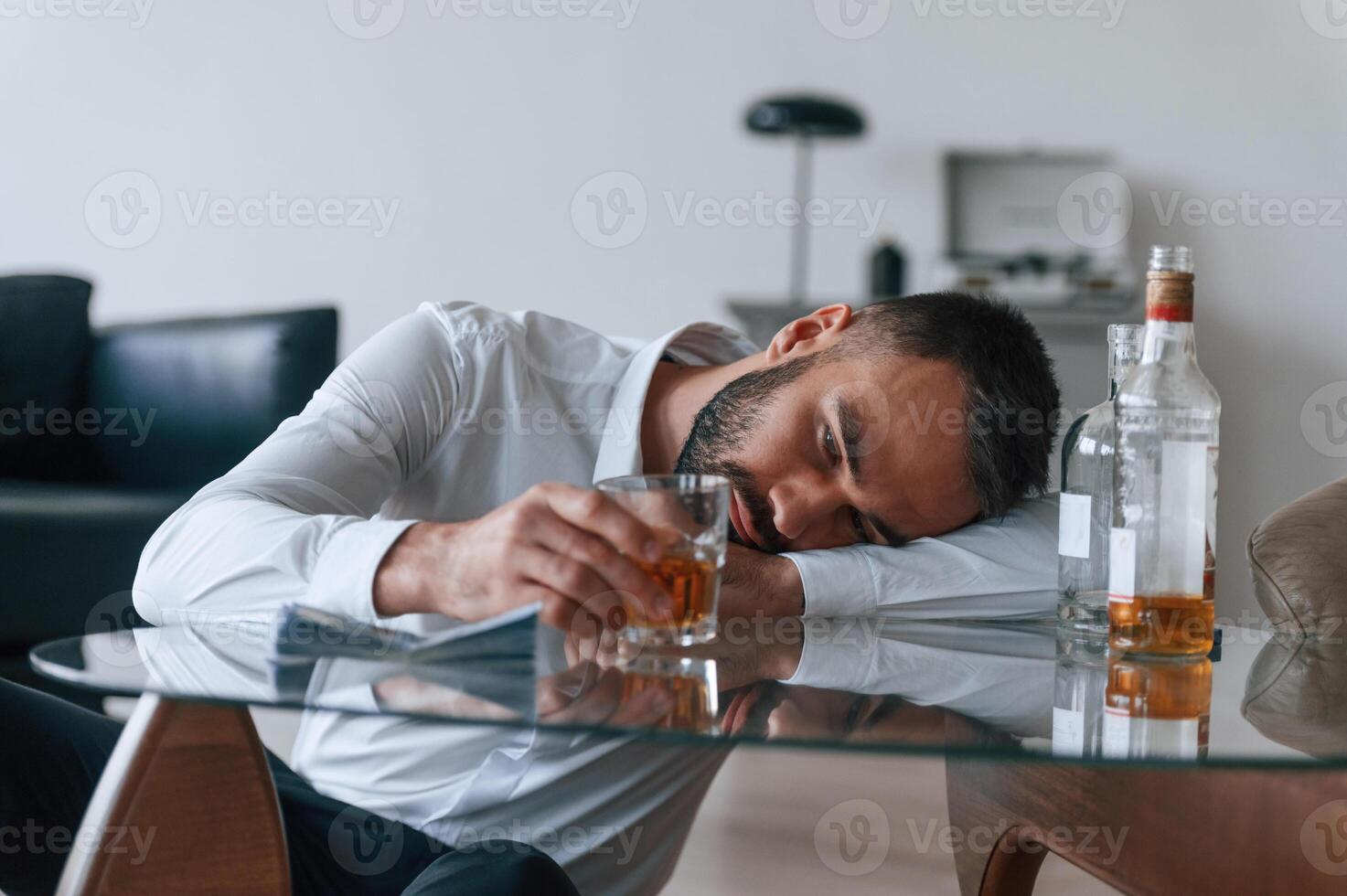 Life ,crisis. With whiskey. Upset young man drinker alcoholic is indoors photo
