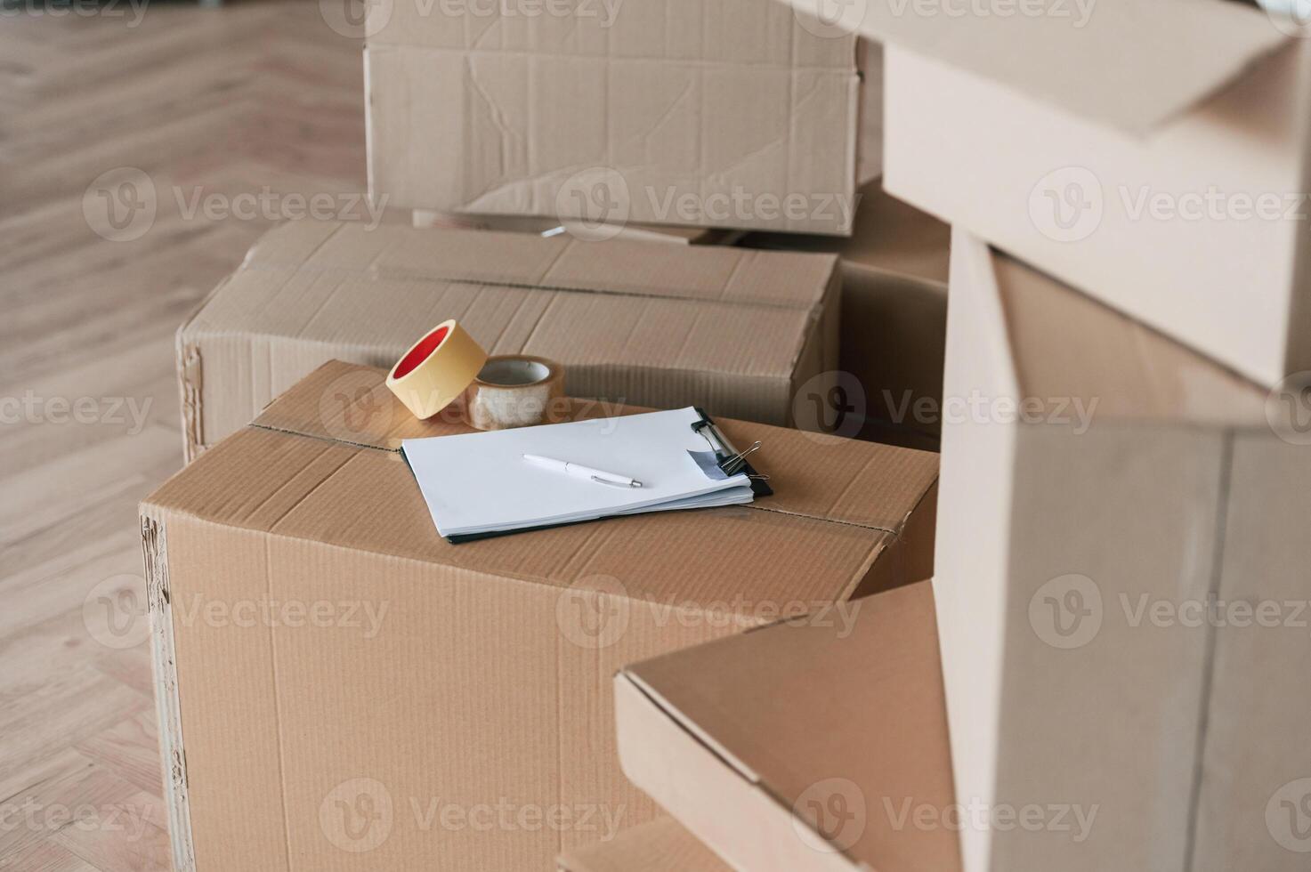 Boxes with scotch tape and notepad. Conception of moving to new house photo
