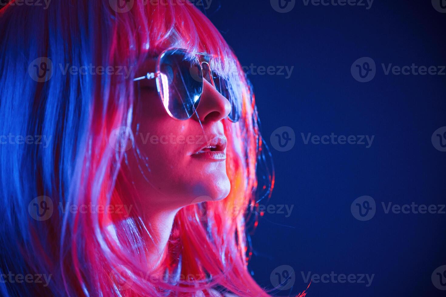 White hair, of, medium ,length. Woman is in studio with neon colors photo