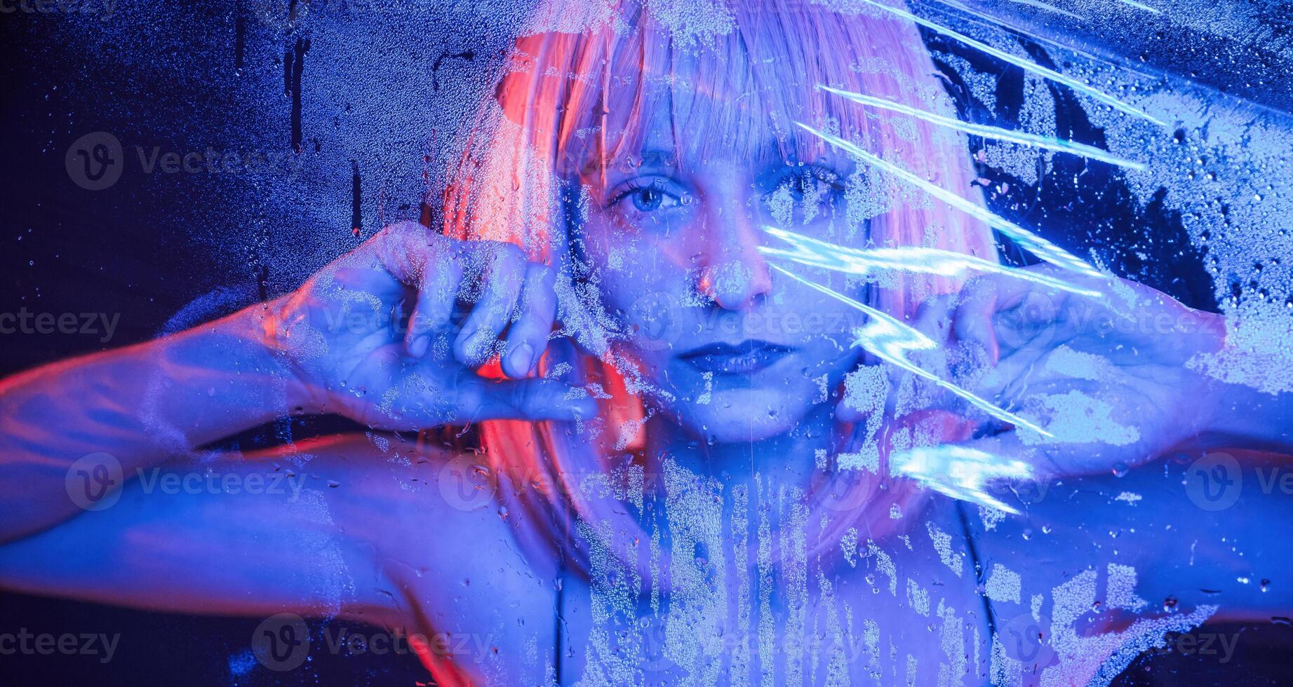 Futuristic ,style. Stylish woman with white hair is behind wet transparent plastic sheet photo