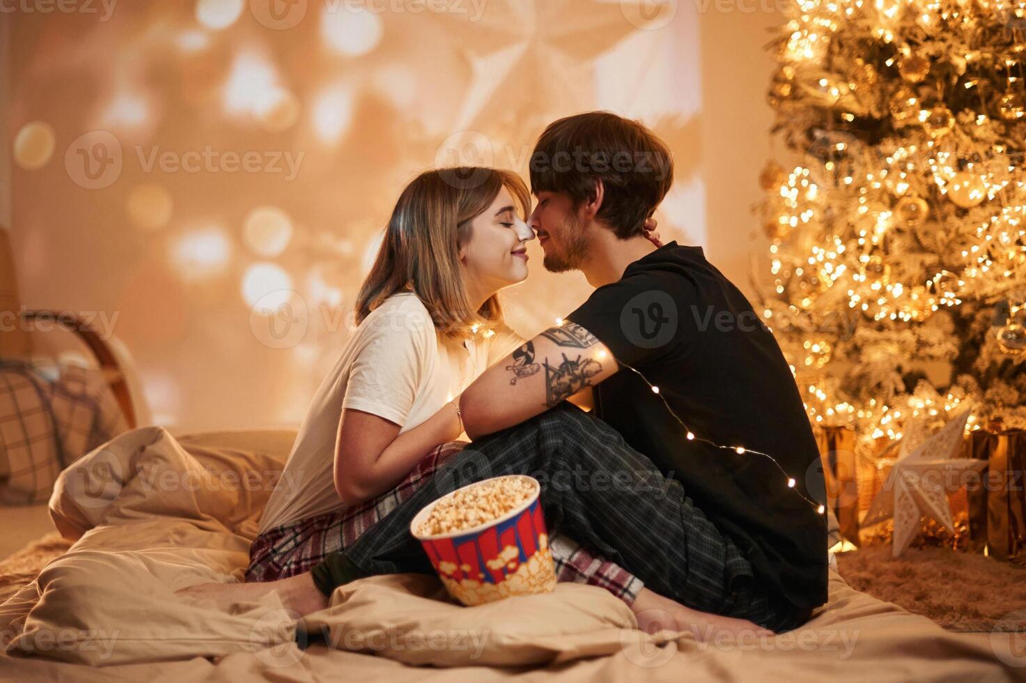 Conception,, of, love. Beautiful young couple indoors, celebrating new year against projector photo