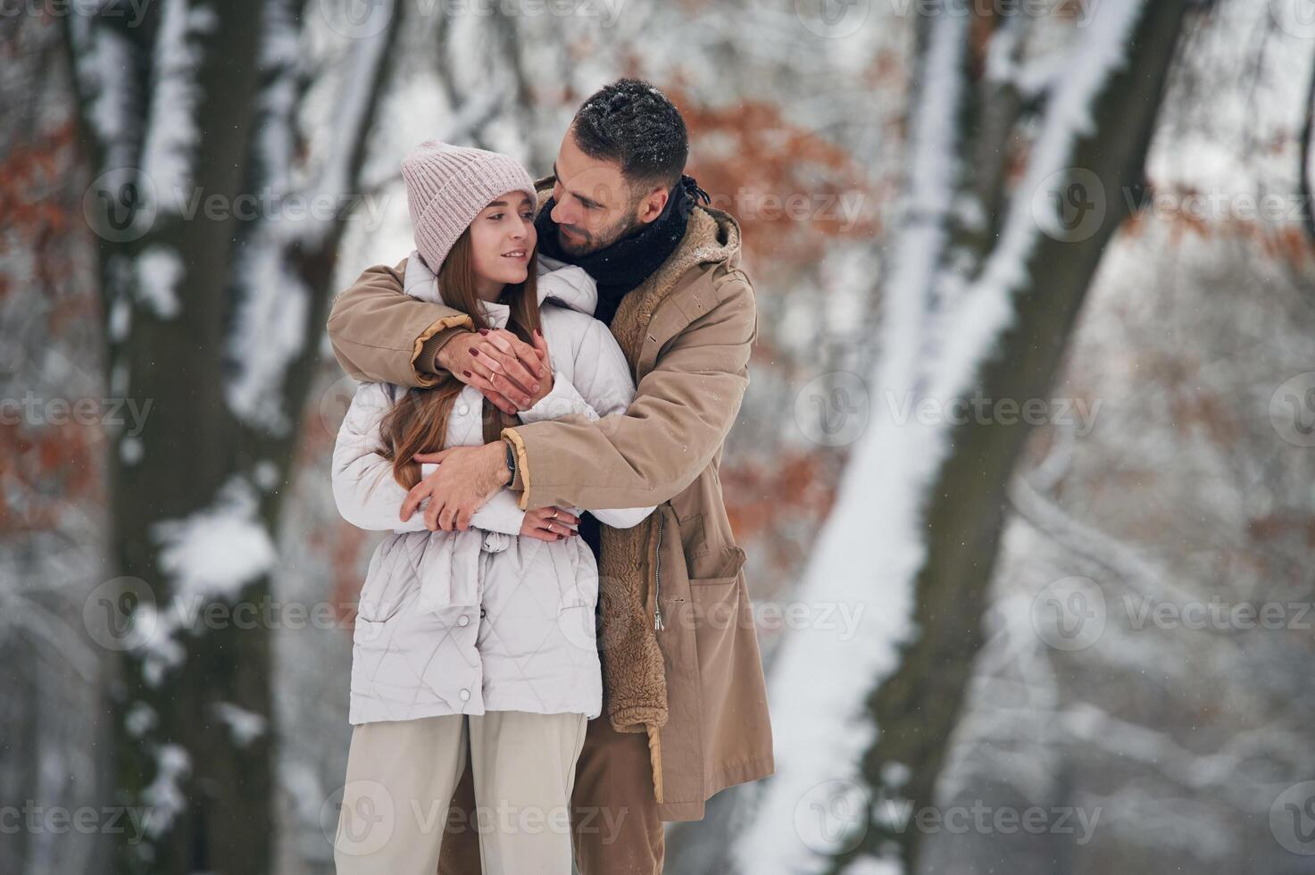 Looking, at ,each other. Lovely couple have a walk in the winter forest photo