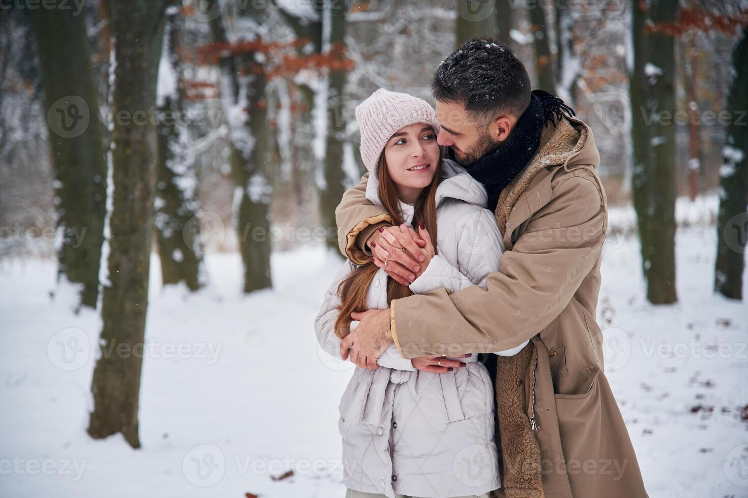 Conception, of love. Couple have a walk in the winter forest photo