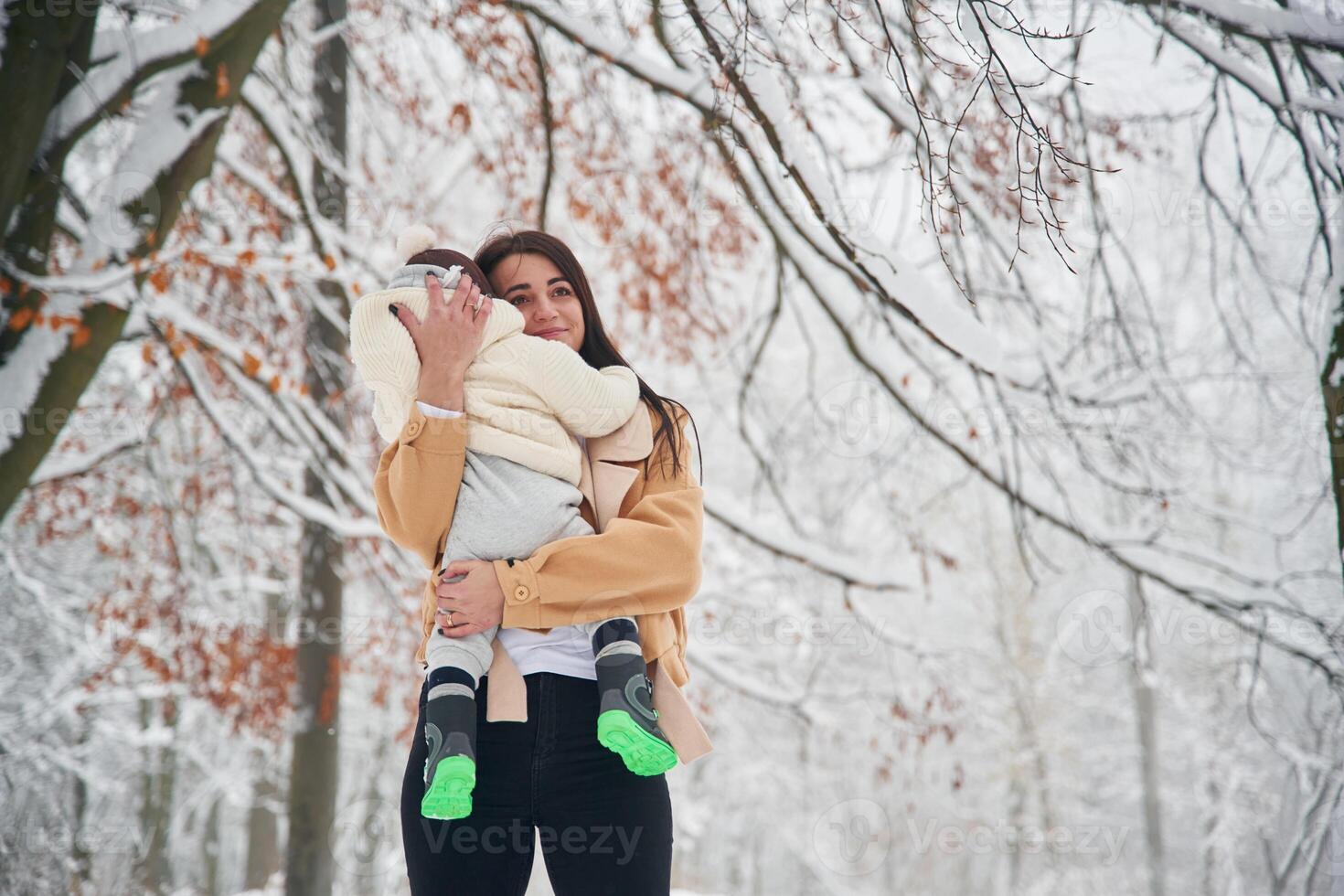 Woman, with, her little boy is in the winter forest on the meadow photo