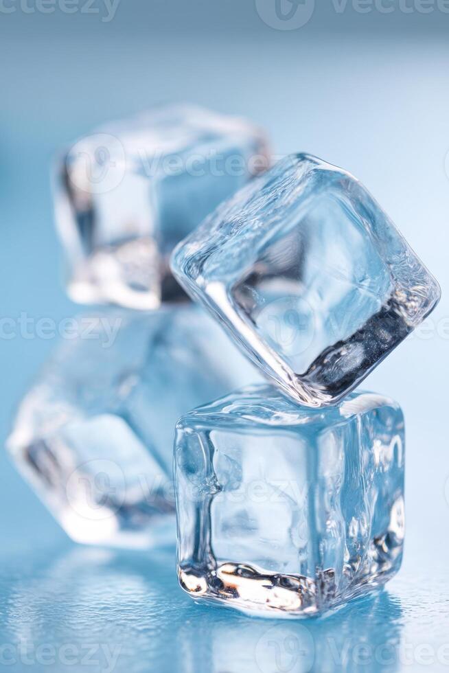 Ice cubes stacked on a blue surface creating a refreshing and cool atmosphere ideal for beverages and summer drinks healthy lifestyle concept photo