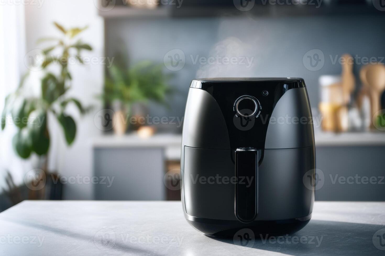 Black air fryer emitting steam in modern kitchen photo