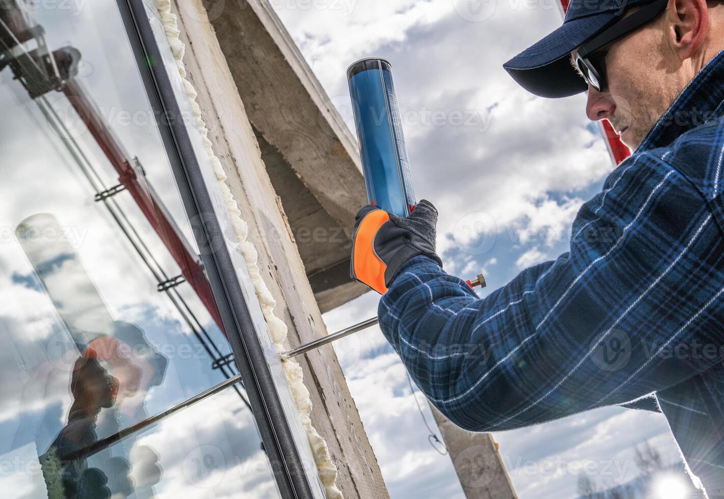 Worker Installing Glass in a Construction Project Under Cloudy Sky photo