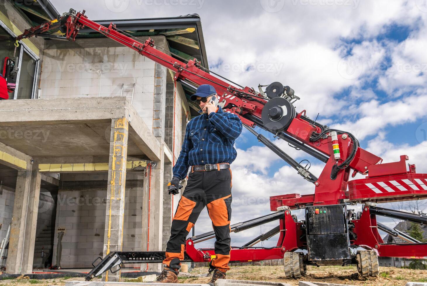 Construction Worker Using Machinery at Building Site in Daylight photo