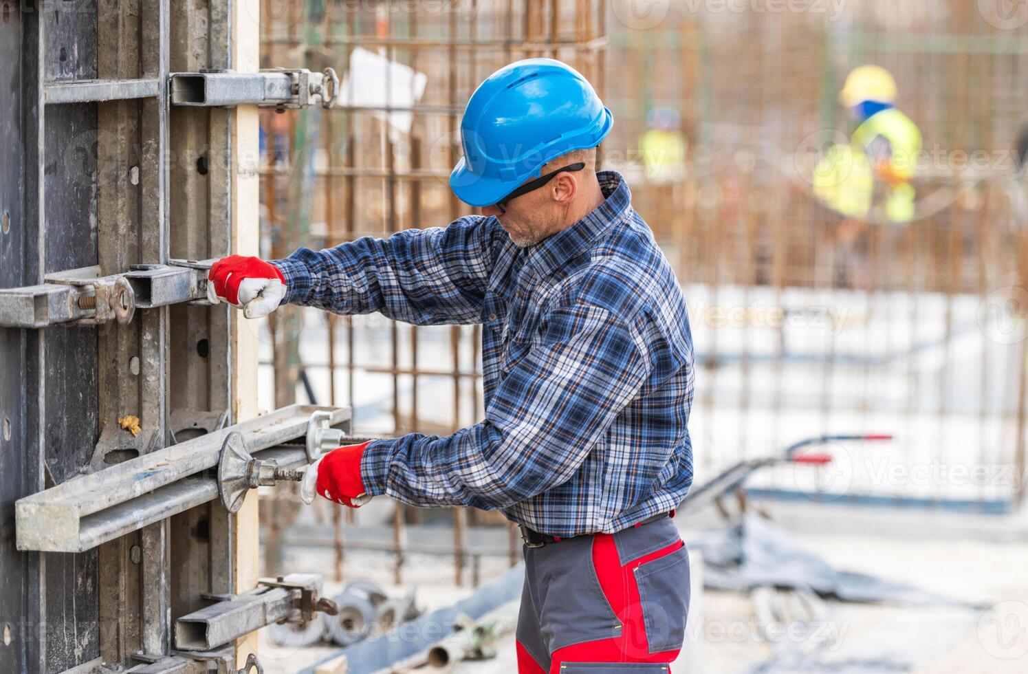 Construction Worker Using Tools at a Building Site in Daylight photo