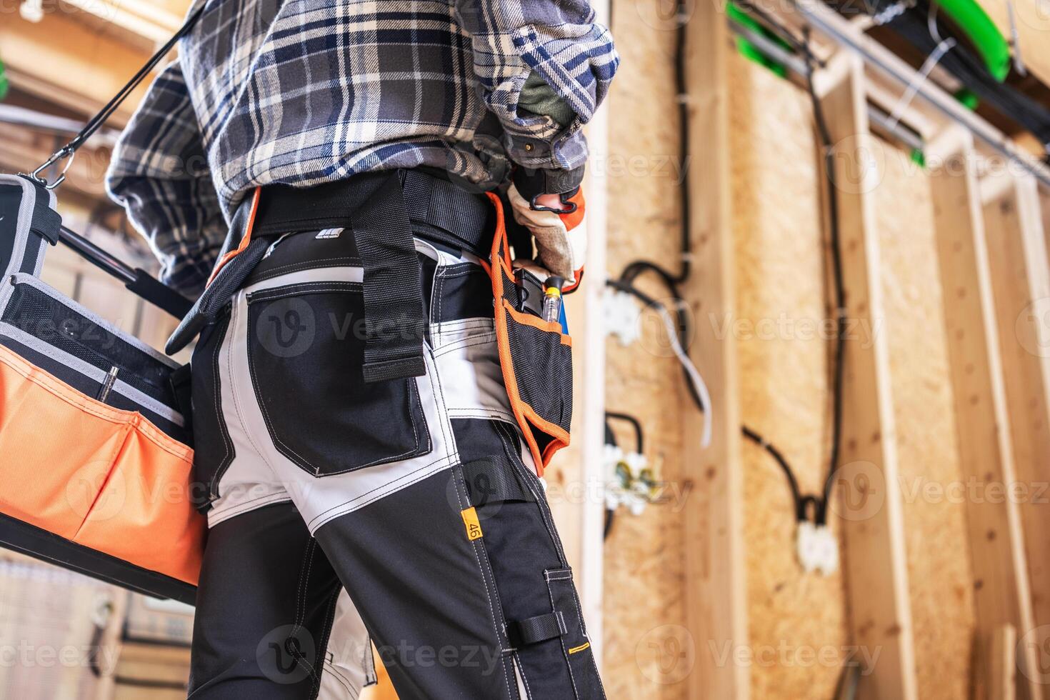 Construction Worker Preparing Tools in a Busy Workshop Space photo