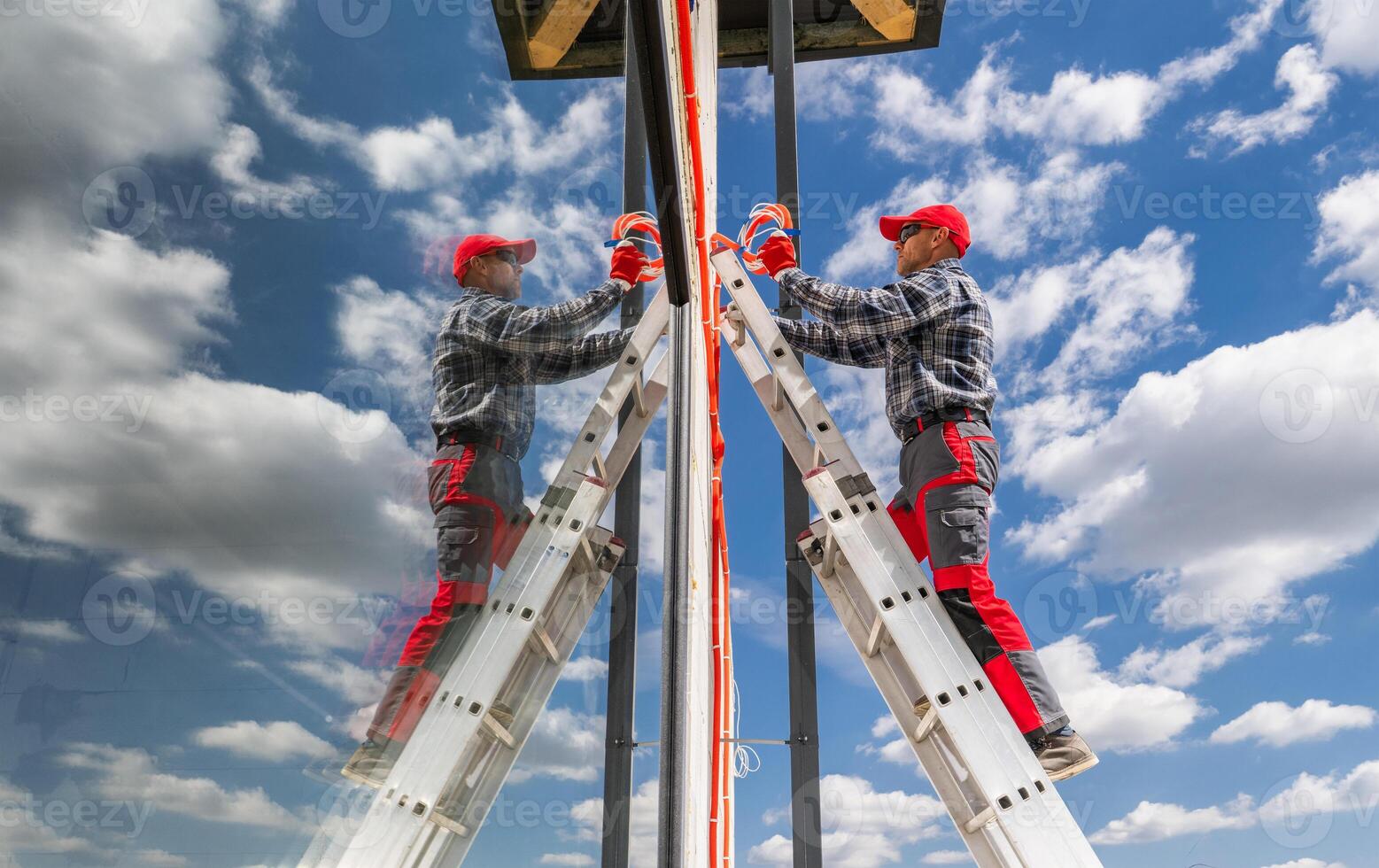 Worker Climbing Ladder for Maintenance on a Clear Day photo