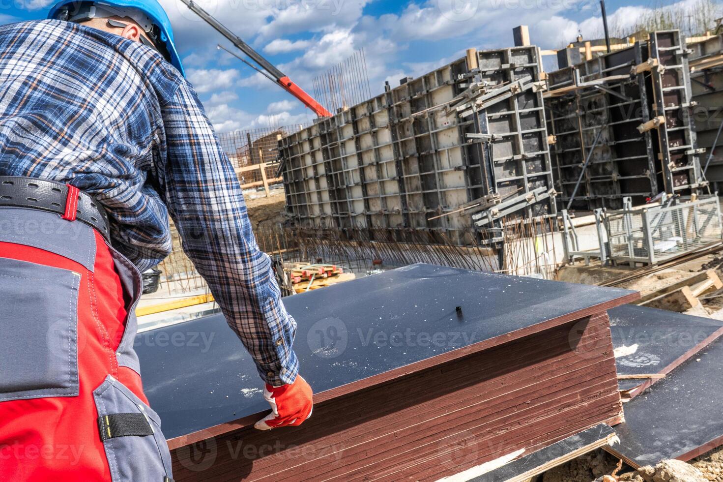 Construction Worker Handling Materials at a Building Site in Spring photo