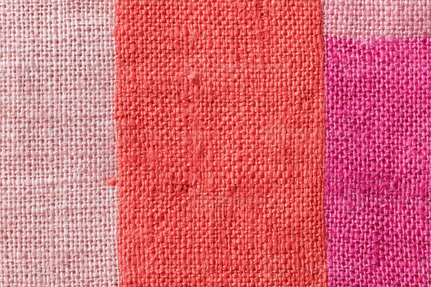 Colorful linen fabric featuring pink, blush and vermillion hues creating a vibrant textile background photo