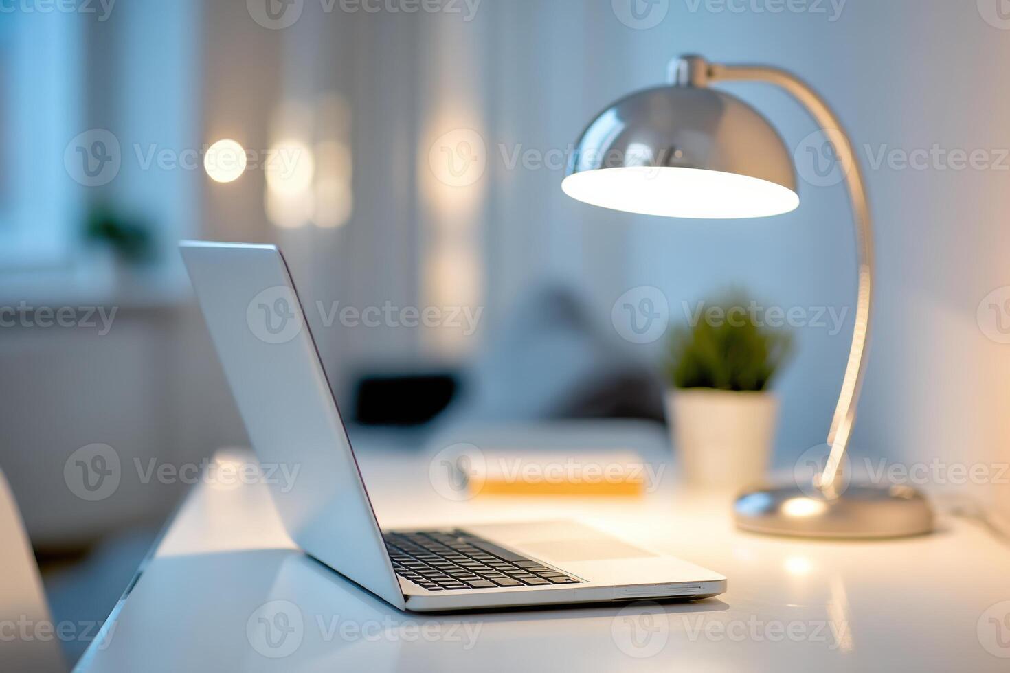 workspace at illuminated by laptop and desk lamp photo
